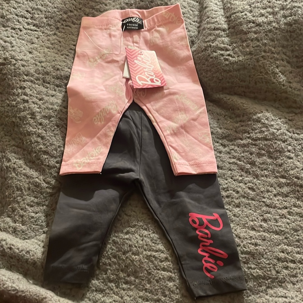 Two pairs of Barbie pants one pink and one black